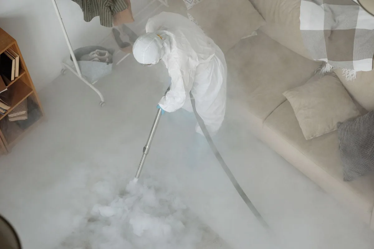 Biohazard cleanup technician in protective equipment, Baltic, CT